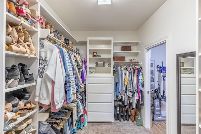 walk in closet with carpet