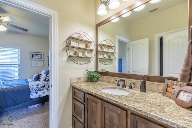 ensuite bathroom featuring visible vents, ceiling fan, vanity, and ensuite bathroom