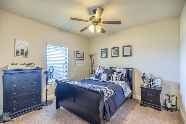 carpeted bedroom featuring baseboards and ceiling fan