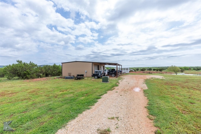 exterior space with a garage, an outdoor structure, an outbuilding, and driveway
