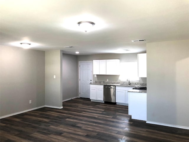 kitchen with stainless steel dishwasher, a sink, baseboards, and white cabinets