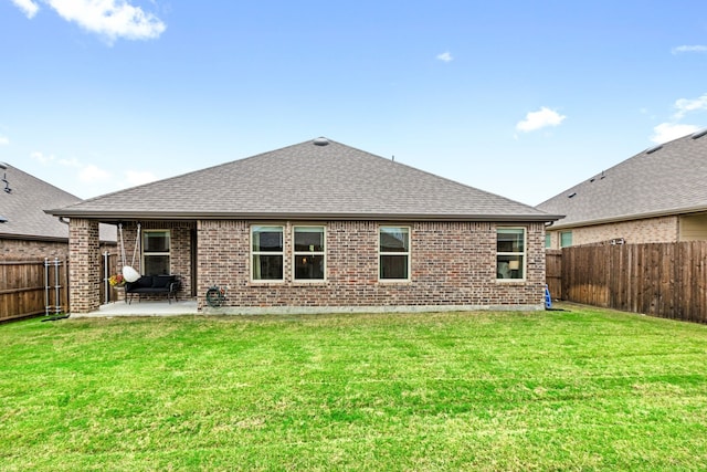 604 Stampede Ln, Princeton, TX 75407 - rear view of house with roof with shingles, brick siding, and a patio