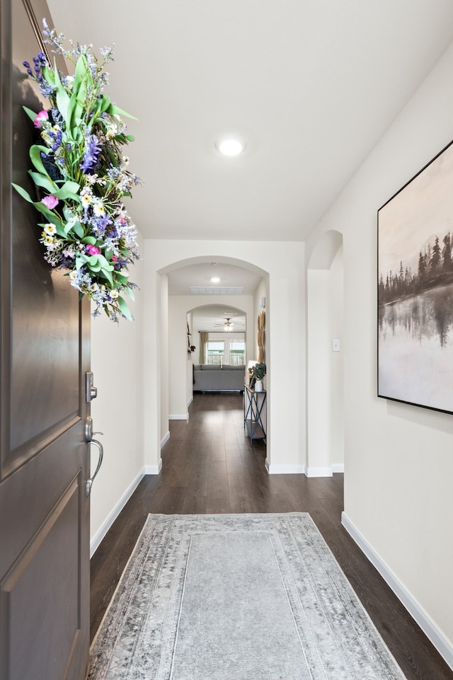 604 Stampede Ln, Princeton, TX 75407 - foyer featuring arched walkways, dark wood-style flooring, and baseboards