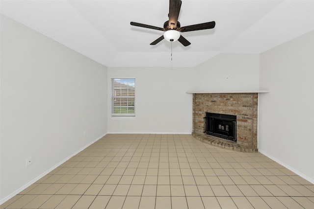 unfurnished living room featuring baseboards, a ceiling fan, and a brick fireplace