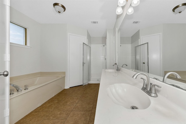 bathroom with a sink, a stall shower, a bath, and visible vents