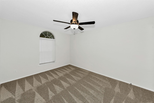 unfurnished room with baseboards, carpet flooring, and ceiling fan