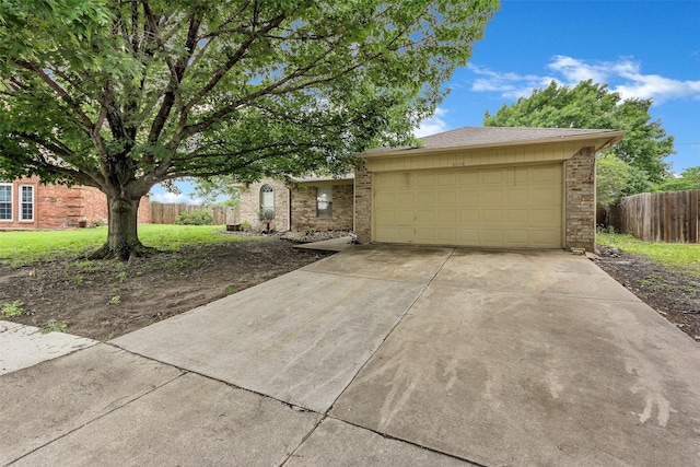 view of front of house with brick siding, fence, and a front yard