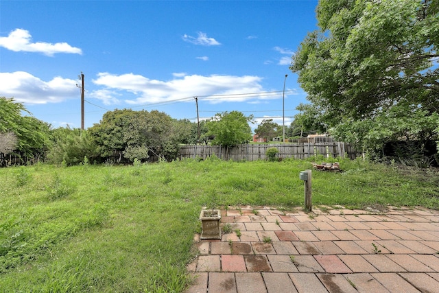 view of yard featuring a patio and fence