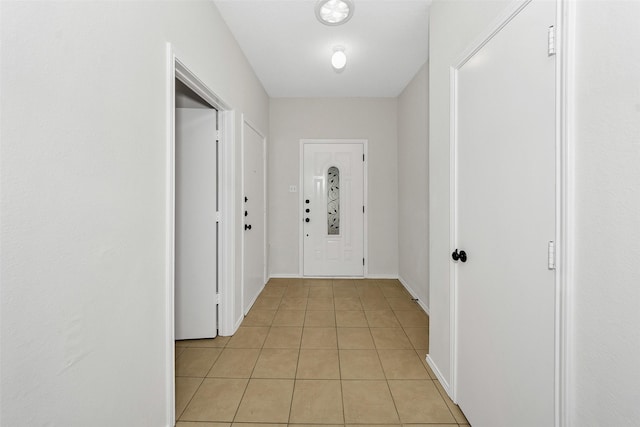 entryway featuring light tile patterned floors and baseboards