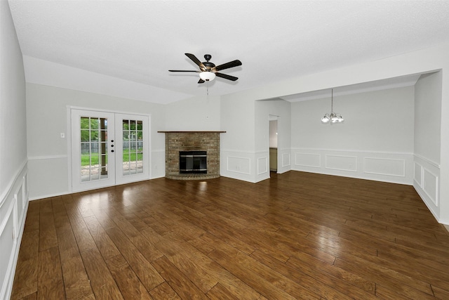 unfurnished living room featuring a decorative wall, dark wood-type flooring, and a wainscoted wall