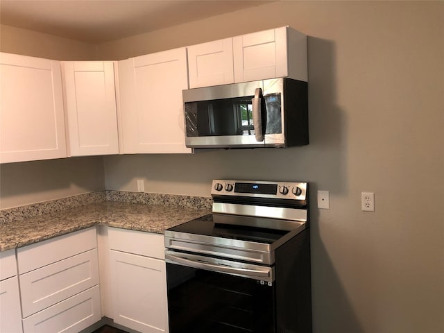 kitchen with white cabinets and appliances with stainless steel finishes