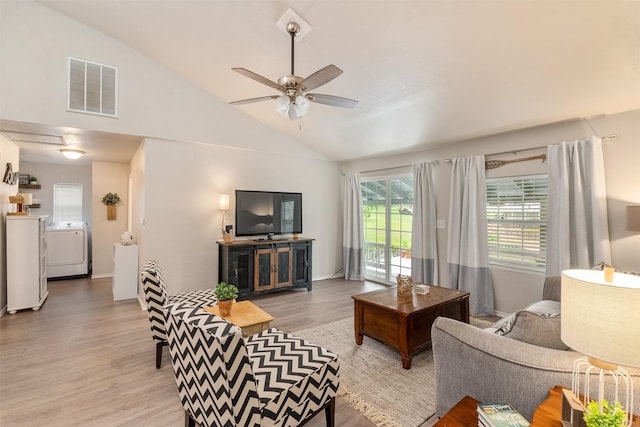 living room with separate washer and dryer, light wood-style flooring, a ceiling fan, lofted ceiling, and visible vents