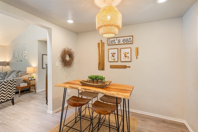 dining space with baseboards, recessed lighting, and wood finished floors