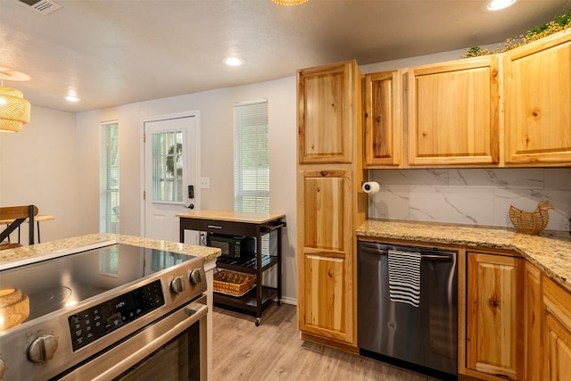kitchen with electric range, light stone countertops, light wood-type flooring, recessed lighting, and tasteful backsplash