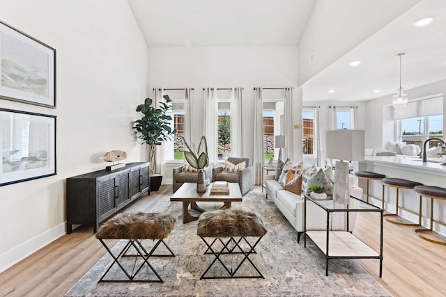 living room featuring baseboards, recessed lighting, and wood finished floors