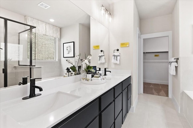 full bathroom featuring visible vents, a shower stall, a sink, and tile patterned flooring