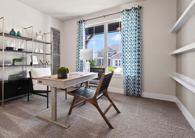 carpeted home office featuring baseboards