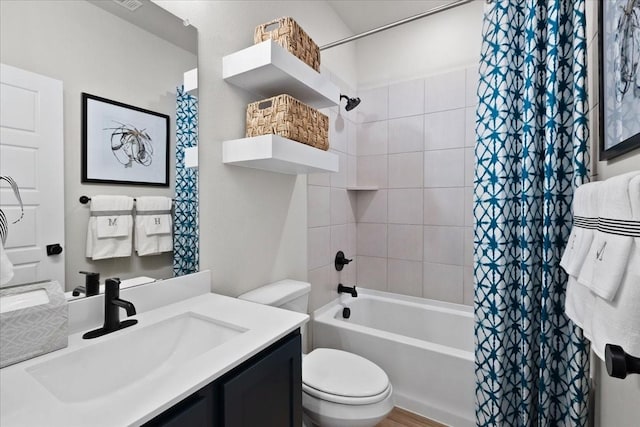 bathroom featuring shower / bath combo with shower curtain, toilet, and vanity