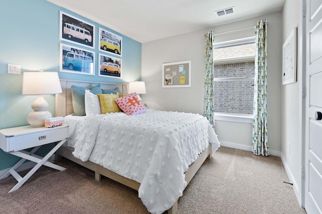 carpeted bedroom featuring visible vents and baseboards