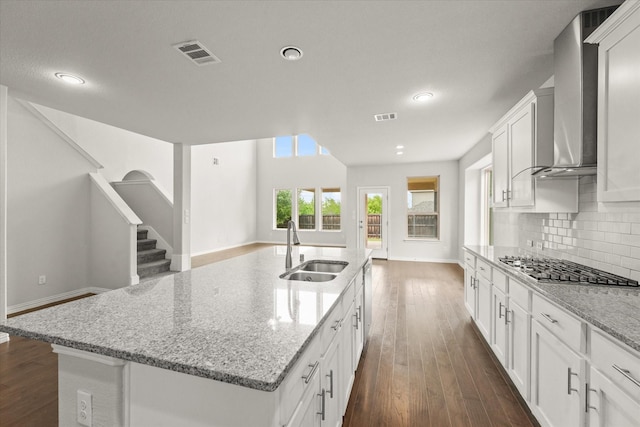 1617 Beauregard Point Dr, Wylie, TX 75098 - kitchen featuring visible vents, dark wood-style flooring, recessed lighting, wall chimney exhaust hood, and a sink