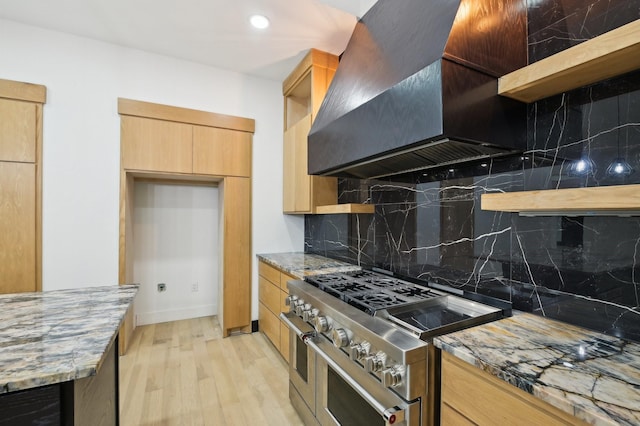 4219 Hollow Oak Dr, Dallas, TX 75287 - kitchen featuring open shelves, light wood-style floors, wall chimney range hood, range with two ovens, and light stone counters