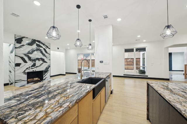 4219 Hollow Oak Dr, Dallas, TX 75287 - kitchen with visible vents, light wood-style floors, open floor plan, a sink, and dishwasher