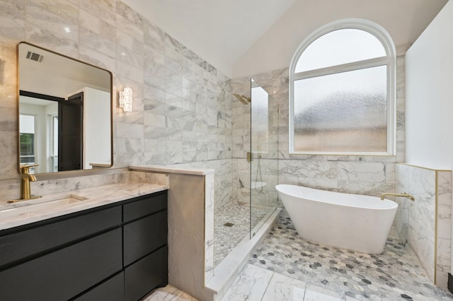 4219 Hollow Oak Dr, Dallas, TX 75287 - full bath featuring tile walls, a stall shower, marble finish floor, and a wealth of natural light