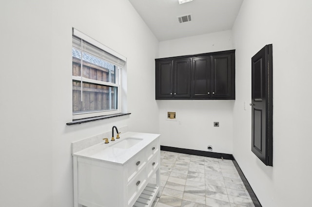 4219 Hollow Oak Dr, Dallas, TX 75287 - laundry area featuring hookup for an electric dryer, visible vents, a sink, hookup for a washing machine, and marble finish floor