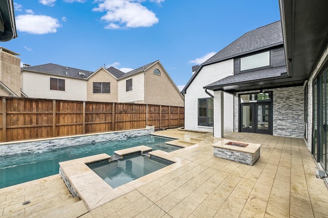 4219 Hollow Oak Dr, Dallas, TX 75287 - view of swimming pool featuring a pool with connected hot tub, a fire pit, and a fenced backyard