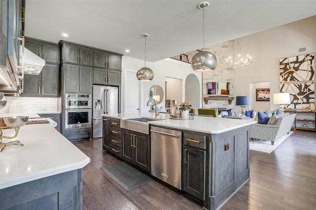 kitchen featuring a sink, decorative backsplash, appliances with stainless steel finishes, and light countertops