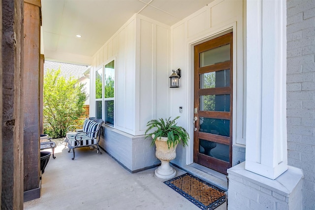 entrance to property featuring board and batten siding and a porch
