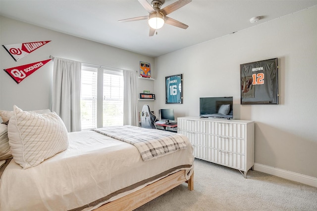 bedroom featuring baseboards, light carpet, and a ceiling fan