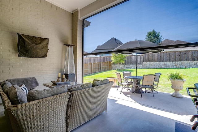 view of patio featuring outdoor dining area, an outdoor living space, and a fenced backyard