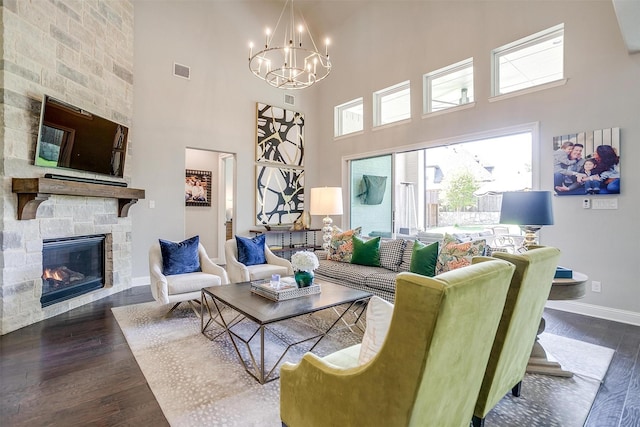 living room with visible vents, dark wood-style flooring, a high ceiling, and a notable chandelier
