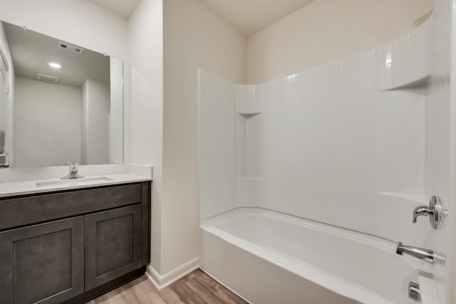 bathroom featuring shower / washtub combination, vanity, wood finished floors, and visible vents