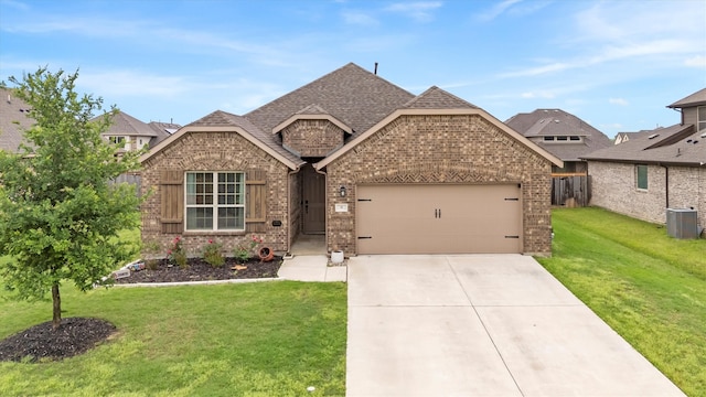 view of front of house featuring an attached garage, a front yard, driveway, and brick siding