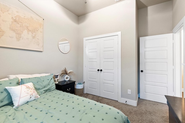 carpeted bedroom with baseboards and a closet