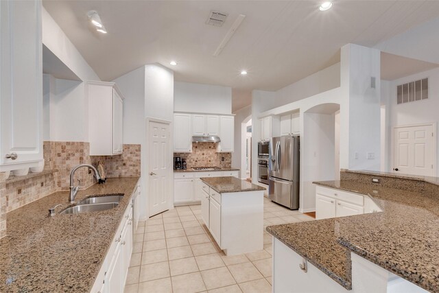 kitchen with visible vents, a sink, stone counters, and appliances with stainless steel finishes