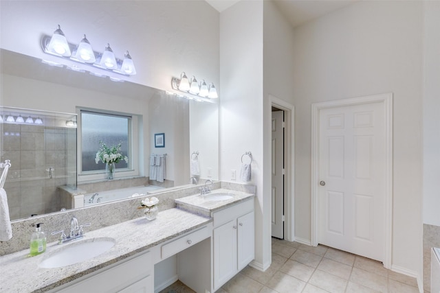 full bath featuring a sink, tile patterned floors, a tile shower, and a garden tub