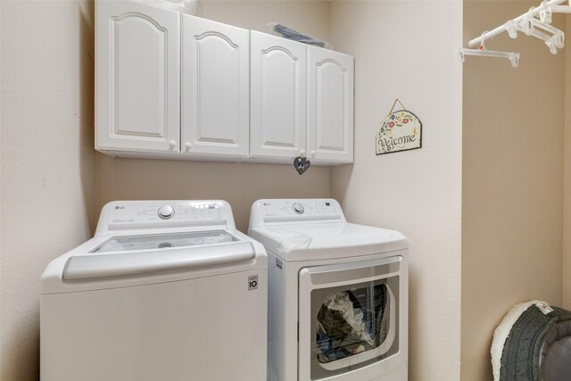laundry area with cabinet space and washer and dryer