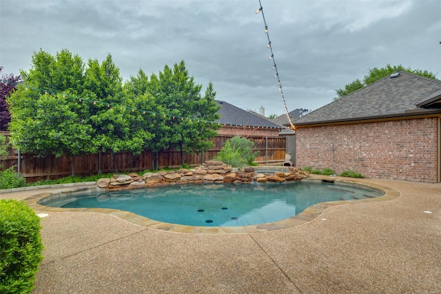 view of swimming pool with a fenced in pool, a fenced backyard, and a patio