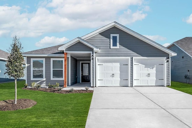 view of front of home with an attached garage, driveway, and a front yard