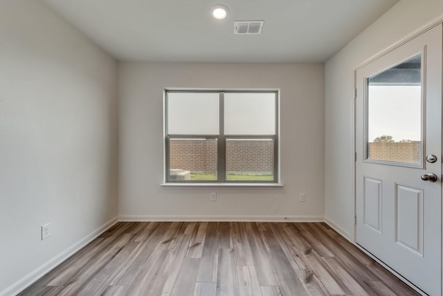 interior space featuring a wealth of natural light, wood finished floors, and visible vents