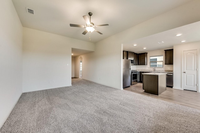 kitchen with visible vents, dark brown cabinets, ceiling fan, and open floor plan