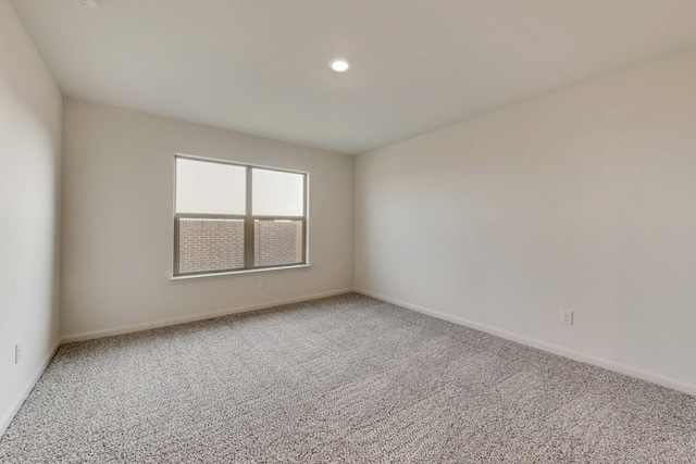 empty room featuring baseboards, carpet, and recessed lighting