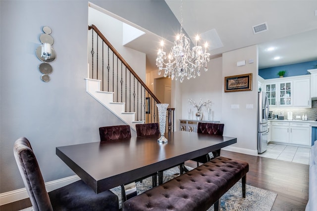 3504 Perkins Ln, Mckinney, TX 75072 - dining room with light wood-style floors, a chandelier, stairs, baseboards, and visible vents