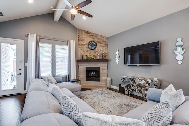 3504 Perkins Ln, Mckinney, TX 75072 - living room with visible vents, wood finished floors, ceiling fan, vaulted ceiling with beams, and a tile fireplace