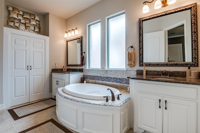 3504 Perkins Ln, Mckinney, TX 75072 - bathroom with a sink, two vanities, a bath, and a wealth of natural light
