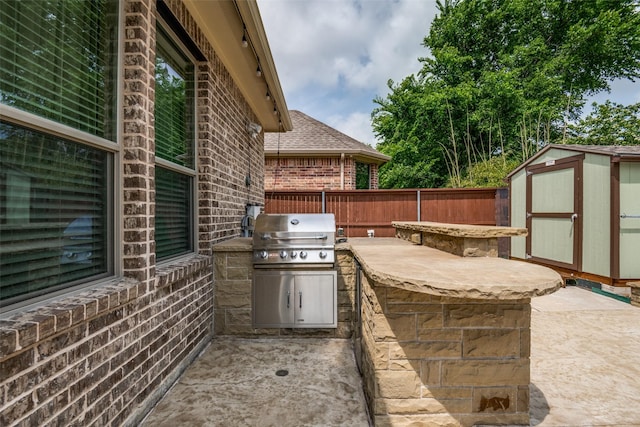 3504 Perkins Ln, Mckinney, TX 75072 - view of patio / terrace with a fenced backyard, a storage unit, an outdoor structure, and area for grilling