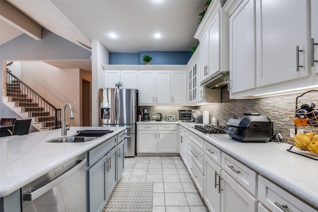 3504 Perkins Ln, Mckinney, TX 75072 - kitchen with decorative backsplash, light countertops, white cabinets, a sink, and appliances with stainless steel finishes